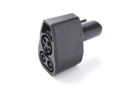 Black cylindrical NACS EV electrical connector with multiple sockets CCS on a white background